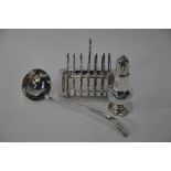 A silver sugar caster and electroplated ladle and toast rack
