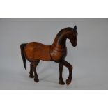 A late 19th or early 20th century Chinese carved hardwood Tang style horse, 62 cm high