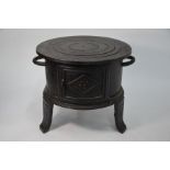 A small cast iron RBF stove with concentric removable top-plates