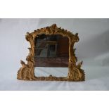 A George III giltwood framed overmantle mirror in the Rococo style