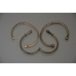 Three modern silver and white metal open bangles