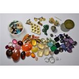 A tin of assorted loose gemstones