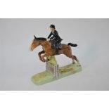 Beswick, showjumper seated side saddle clearing, a fence, circa 1948