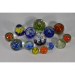 Fourteen various floral specimen paperweights