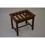 A vintage mahogany luggage stand