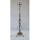 An Arts & Crafts brass tripod standard lamp