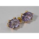 A Victorian brooch featuring two pale oval amethysts