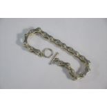 A white metal bracelet in the form of a bicycle chain