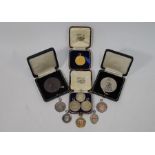 A collection of various silver and silver-gilt cycling medals