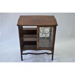 An Art Nouveau period walnut low library/display cabinet in the manner of Liberty