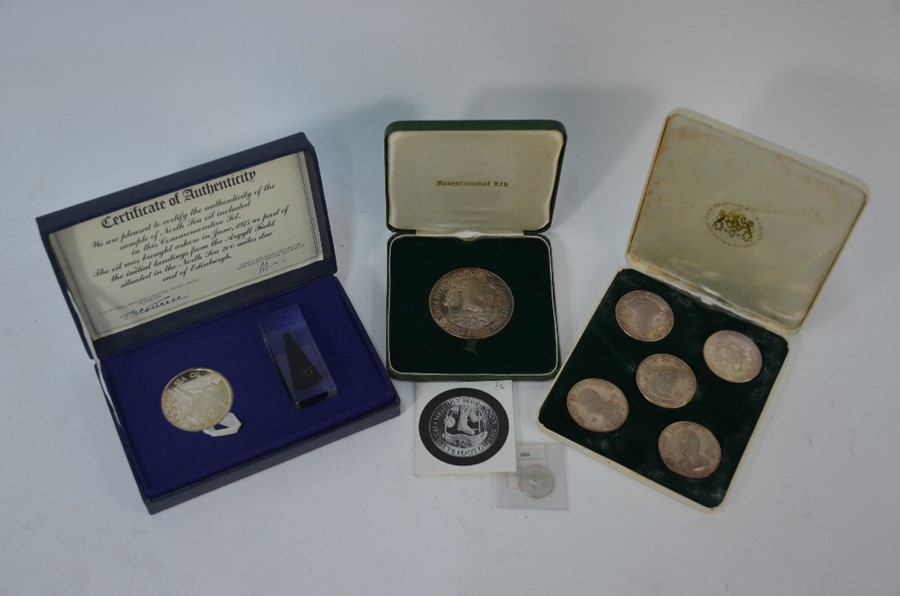 A collection of silver crowns and medallions