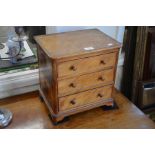 A mahogany three drawer table top collector's chest