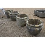 A set of four cast reconstituted stone garden planters