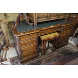 A large mahogany twin pedestal desk with inset green leather top