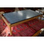 A modern teak coffee table with rectangular imitation slate top