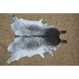 A Brazilian brown and white cow hide rug retailed by Ecotan