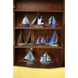 A collection of eleven stained glass model/paperweight yachts
