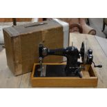 A vintage Jones hand-sewing machine in case