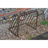 An old wall mounting wrought metal hay rack feeder