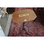 A mahogany side table on tripod supports with inset cribbage board to centre