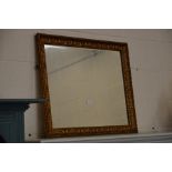 A rectangular bevelled wall mirror