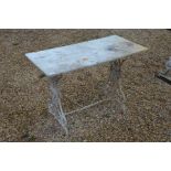 A rectangular marble top garden table