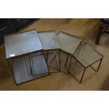 A set of four contemporary graduating and nesting square steel stands