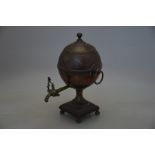 A mid 19th century copper and brass ball samovar on bun feet