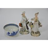 Two 18th century Derby porcelain small figures and a Worcester tea bowl