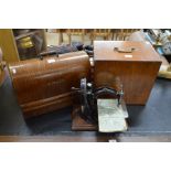 Two vintage sewing machines in wooden cases