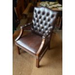 A mahogany framed armchair with studded button-back brown leather