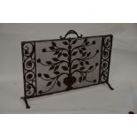 A 1950s wrought iron and mesh fire screen