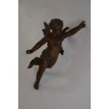 A bronze sculpture of a winged cherub