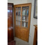 A large antique pine floor standing corner cupboard