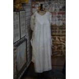 An early 20th century cream silk night gown