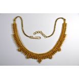 An Indian yellow metal filigree and bead decorated part collar fringe necklet