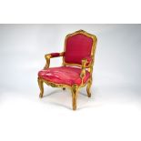 A traditional giltwood framed child's salon armchair