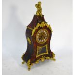A giltwood mounted tortoiseshell mantle clock