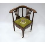 A George III mahogany library corner elbow chair