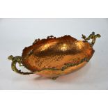 A copper and brass basket with cast dragon handles