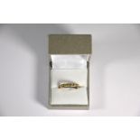 A 9ct yellow gold seven stone half eternity ring