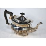 A heavy quality silver half-reeded oval teapot