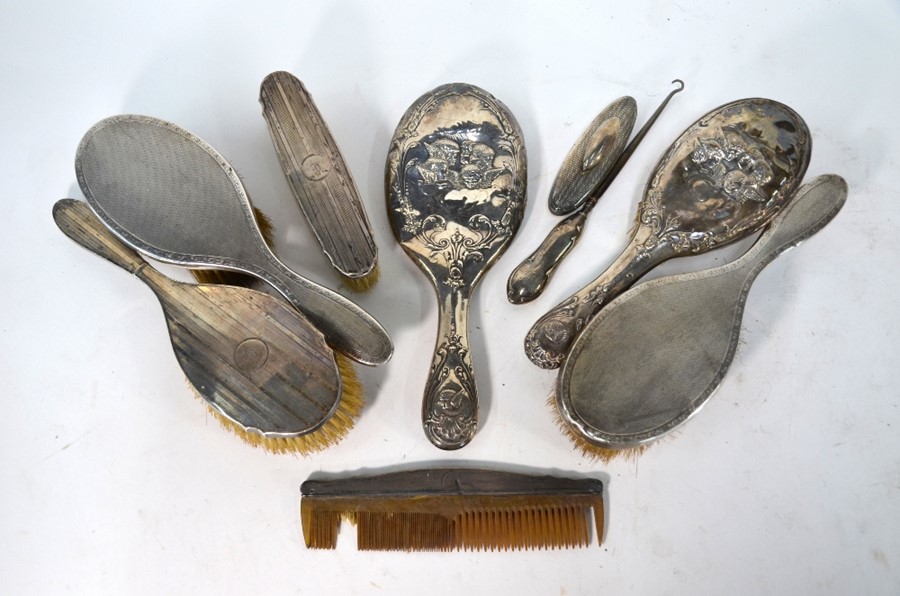 Five various silver-backed hairbrushes etc