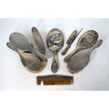 Five various silver-backed hairbrushes etc