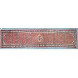 A Persian Hamadan carpet runner