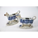 A pair of 19th century pottery cow creamers