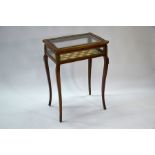 An antique gilt-brass mounted kingwood vitrine table