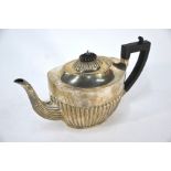 A silver oval half-reeded teapot with composite handle