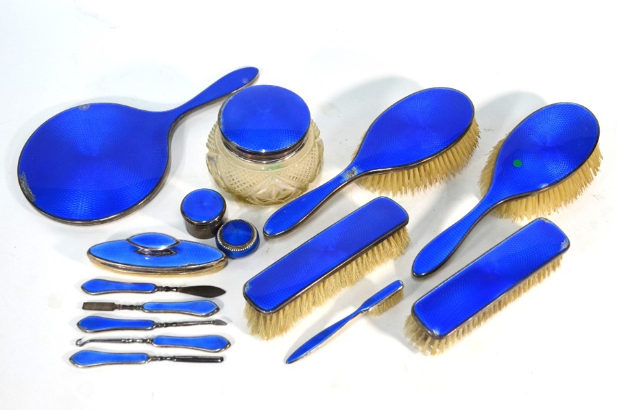 A matched silver and blue basse-taille enamel-mounted dressing table set