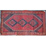 An old Kurdish rug, red ground geometric design, worn/dirty, 284 cm x 153 cm